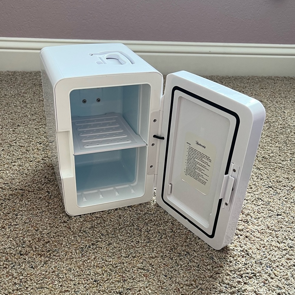 Pink and white mini fridge